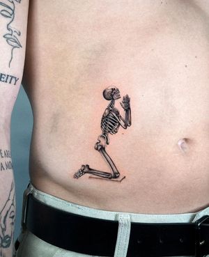 Get a hauntingly beautiful black and gray skeleton tattoo on your stomach by artist Joshua Williams.