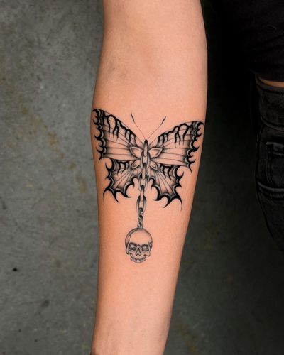 Beautiful black and gray fine line tattoo featuring a butterfly and skull connected by a chain, done by the talented artist Joshua Williams.
