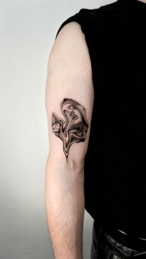 Get a stunning blackwork surreal woman tattoo on your upper arm in Berlin, DE. Embrace unique artistry and make a statement.