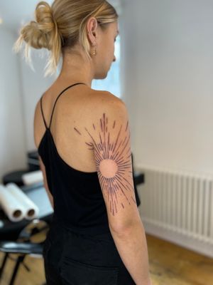 Unique blackwork design by artist Jamie B featuring a bold sun motif and intricate pattern, perfect for upper arm placement.