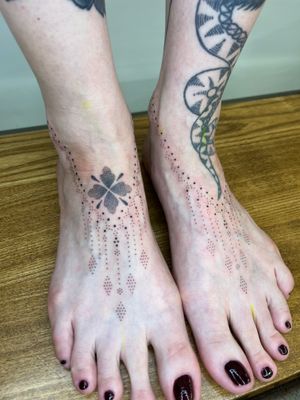 Elegant hand-poked ornamental tattoo of flowers and patterns by Indigo Forever Tattoos, beautifully adorning the foot.