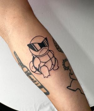 Get inked by Miss Vampira with a stylish blackwork anime design featuring everyone's favorite squirtle on your lower leg.