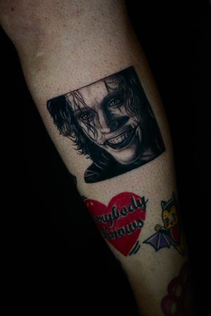 Experience the iconic portrayal of the Joker in stunning blackwork realism by Miss Vampira on your lower leg.