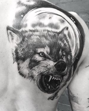 Impressive black and gray realism tattoo of a wolf by VV Swain Tattoo, beautifully placed on the upper back.