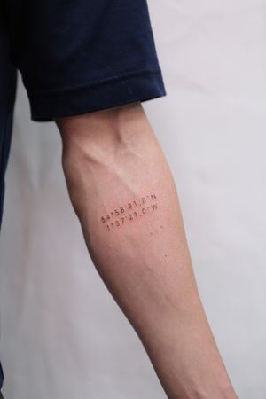 Express your journey and spirit with this exquisite forearm tattoo by artist Jamie B. Featuring delicate lettering and meaningful coordinates.