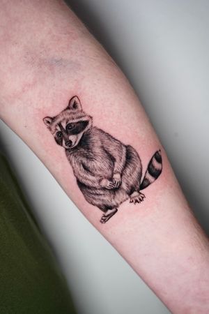 Get an intricate and lifelike raccoon tattoo on your forearm by the talented artist, Miss Vampira. Perfect for nature lovers!
