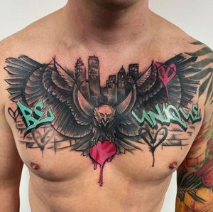 Impressive blackwork chest piece featuring an eagle and powerful quote by VV Swain Tattoo.