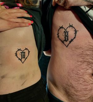 Get a unique tattoo by Frankie Brown combining a heart motif with beautiful lettering on your ribs.