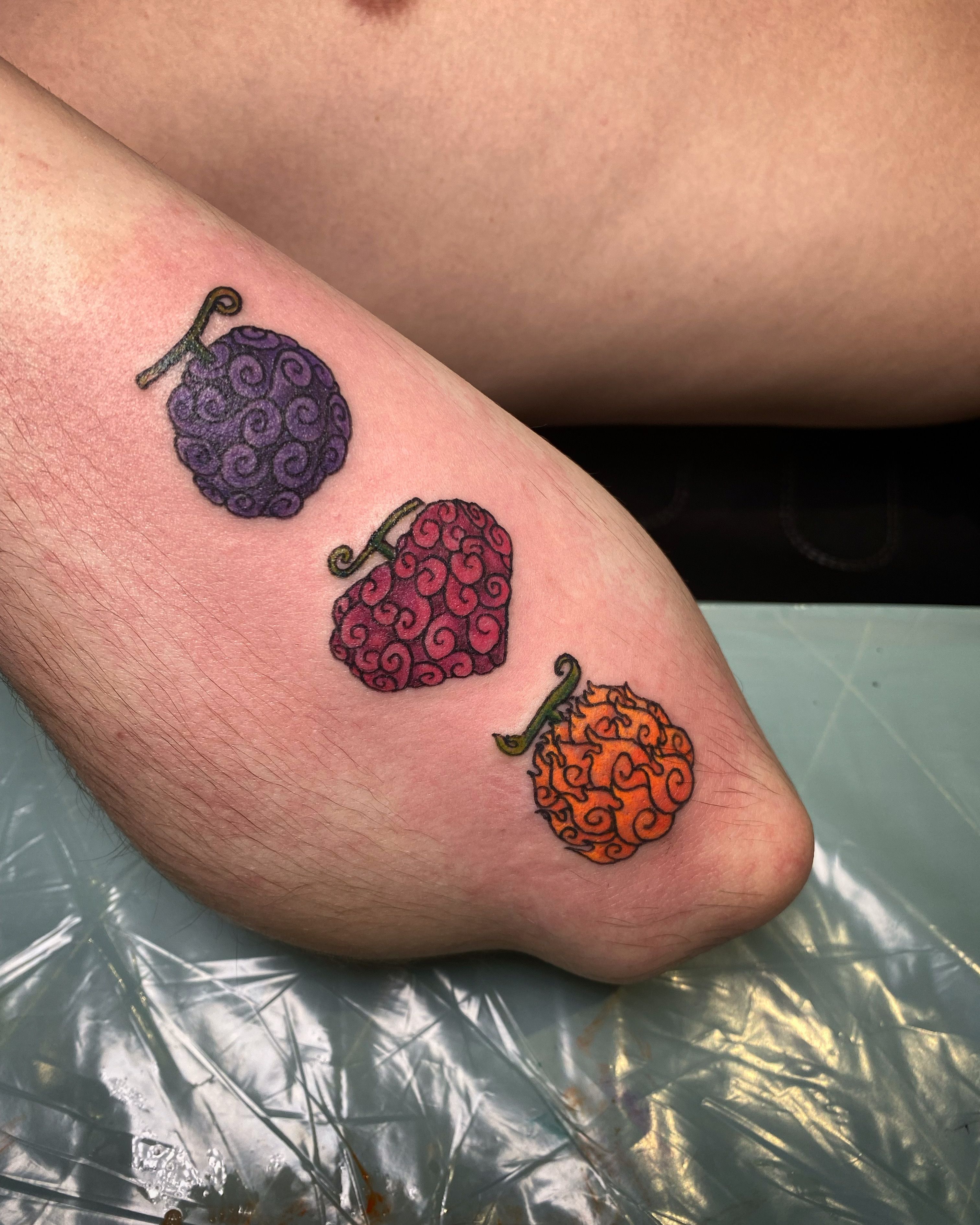 Kawaii style fruit tattoos on the calf.