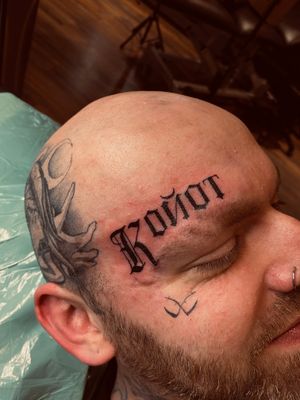 Get inspired with this striking lettering tattoo by Frankie Brown. Let your words stand out on your face with this unique design.