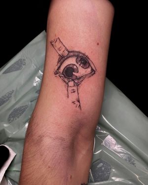 Get a stunning black and gray fine line eye tattoo by artist Frankie Brown for a unique and artistic look.