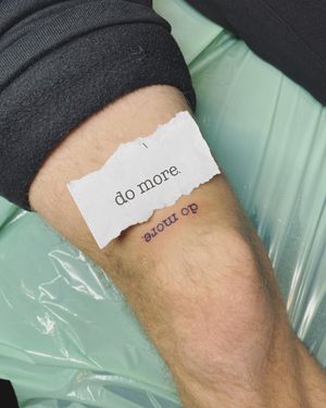 Get inspired with this small lettering quote tattoo by Frankie Brown on your upper leg.