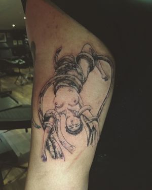 Detailed black and gray tattoo by Frankie Brown featuring an octopus intertwining with a girl on the upper arm.