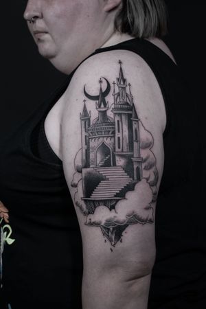 Get lost in the intricate black and gray architecture of Luca Salzano's upper arm masterpiece, featuring stunning cloud motifs.