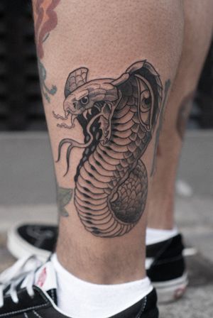 Traditional black & gray snake and eye tattoo on lower leg by artist Luca Salzano.