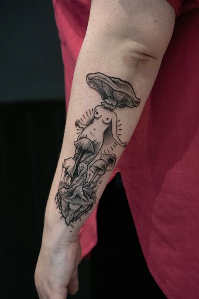 A stunning black and gray fine line tattoo on the forearm featuring a detailed tree, woman, and mushroom, created by Luca Salzano.