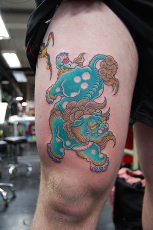 Get inked with a stunning Japanese foo dog tattoo by the talented artist Bananajims on your upper leg. Embrace the power and protection of this mythical creature.