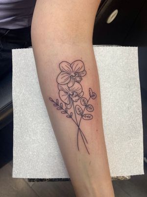 Exquisite fine-line flower and plant design by Joanna Webb for a sophisticated look on your forearm.