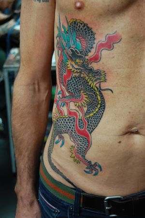 Experience the power and beauty of a Japanese dragon in this intricate rib tattoo by acclaimed artist Bananajims.