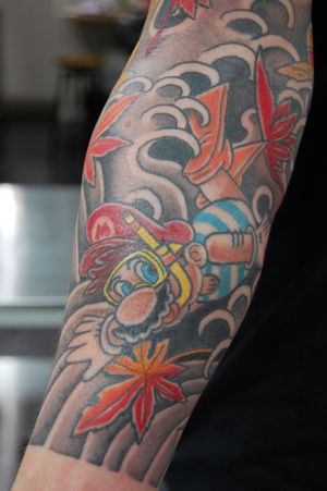 Fun and vibrant new school style Mario tattoo on the forearm by talented artist Bananajims. Bring your favorite video game character to life with this unique design.