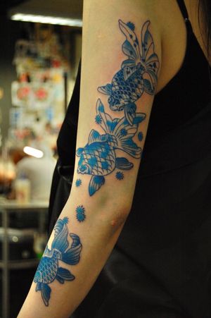 Elegantly designed koi fish tattoo for the upper arm, created by the talented artist Bananajims. Dive into the symbolism and beauty of Japanese artistry with this stunning piece.