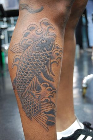 Beautiful Japanese style koi fish tattoo on lower leg by artist Bananajims. Symbolizing perseverance and transformation.