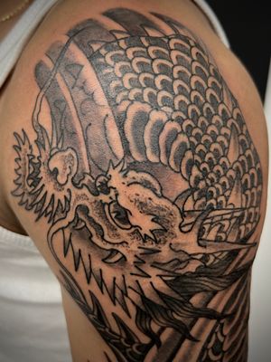 Experience the power and beauty of a traditional Japanese dragon in striking blackwork by Kiko Lopes.