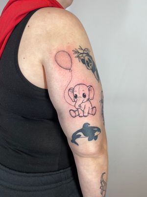 Unique fine line tattoo by Joanna Webb featuring a majestic elephant holding a whimsical balloon design.