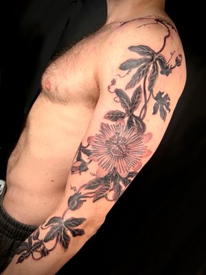 Get inked by Kiko Lopes with a stunning blackwork flower design on your upper arm. A bold and beautiful addition to your body art collection.