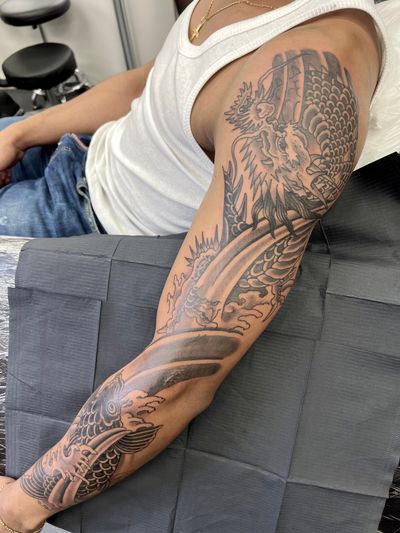 Get fierce with this intricate blackwork dragon sleeve tattoo by Kiko Lopes, inspired by traditional Japanese art styles.