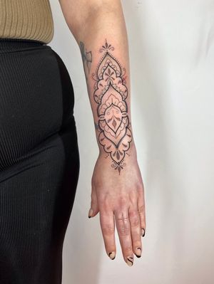 Elegant and detailed forearm tattoo featuring dotwork, fine line, and ornamental styles by renowned artist Joanna Webb.