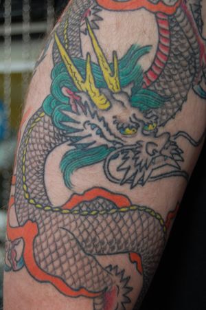 Embrace the power of the mythical dragon with this intricate Japanese style tattoo on your arm, expertly crafted by renowned artist, Bananajims.