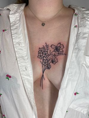 Elegant flower and plant design by Joanna Webb, delicately inked on the chest in fine line style.