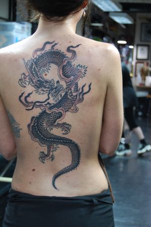 Experience the power and mystique of a Japanese dragon with this stunning tattoo on the back by renowned artist Bananajims.