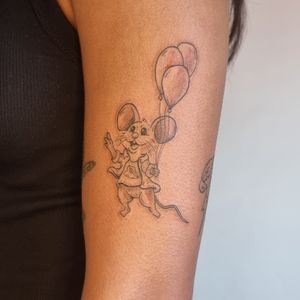 Simple cute illustrated mouse with a balloon on the outer arm 