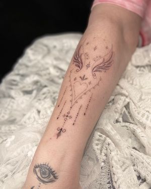 Adorn your forearm with Viví Bogdanov's ornamental dotwork design featuring intricate wing patterns.