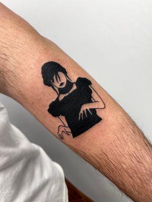 Dark and moody blackwork tattoo of Wednesday Addams by Miss Vampira, perfect for fans of the macabre.