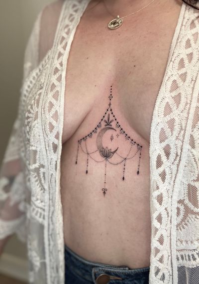 Experience the mesmerizing beauty of dotwork moon and ornamental pattern tattoo by Viví Bogdanov on your sternum. Bring a touch of mystique to your body art.