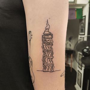 Impressive tattoo of Big Ben and city building in fine line style by tattoo artist Nikki Bostin. Perfect for upper arm placement.