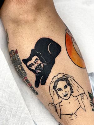 Elegant blackwork tattoo on lower leg by Miss Vampira featuring a cat and a man in a unique artistic style.