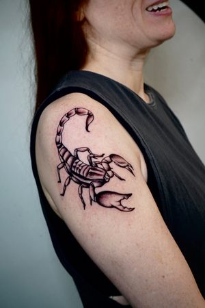 Bold blackwork scorpion tattoo on upper arm by the talented artist Miss Vampira. Edgy and unique design.