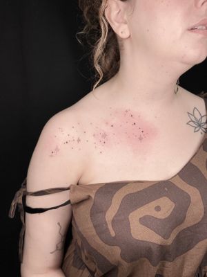Elegant dotwork stars tattoo on chest by talented artist Viví Bogdanov, creating a celestial masterpiece.