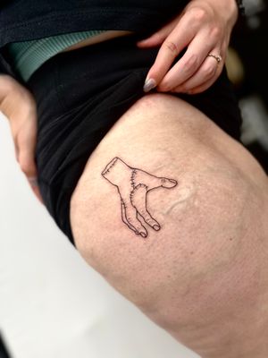 Unique blackwork design by Miss Vampira featuring a hand with stitches, perfect for a bold statement on your upper leg.