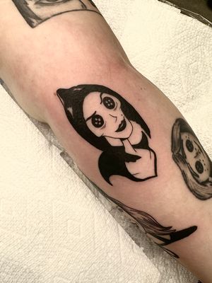 Elegant blackwork tattoo of a woman on the arm, executed by the talented artist Miss Vampira. Unique and striking design.