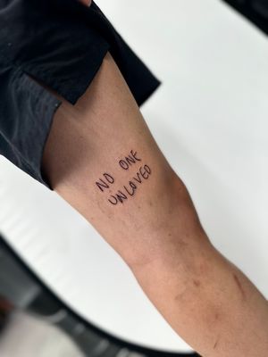 Miss Vampira's powerful quote lettering on upper leg, symbolizing inner strength. Enhance your body art with this meaningful tattoo.