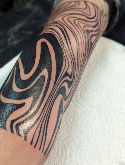 Experience surreal beauty with this mesmerizing pattern blackwork tattoo on your arm by talented artist George Antony.