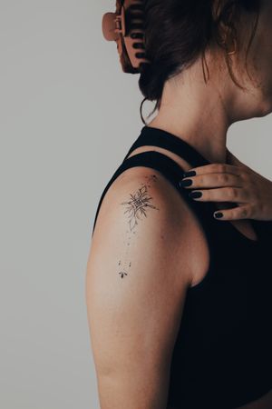 Adorn your upper arm with a beautiful ornamental pattern tattoo by Gabriele Edu. Fine lines create a delicate and intricate design.