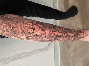 Adorn your lower leg with a stunning blackwork design featuring a beautiful woman and intricate filigree details, expertly done by artist Jones.