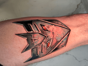 Vibrant new school style tattoo featuring iconic transformers characters by the talented artist Jones.