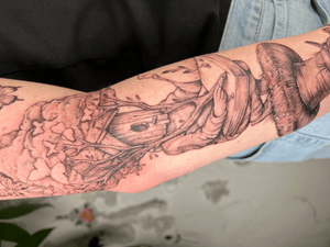 Experience the magic of Jones' blackwork design featuring a tree and house on your arm.